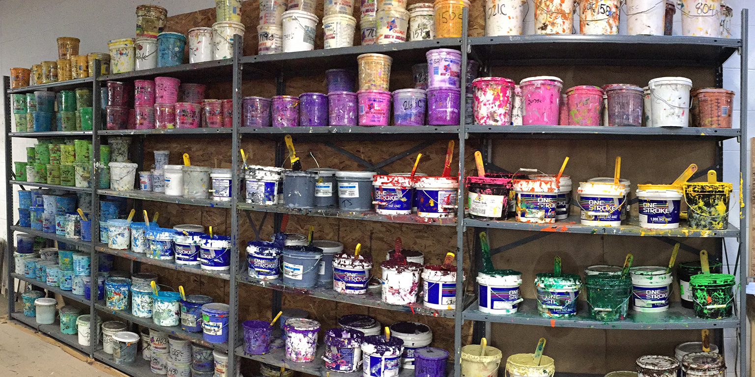 Photograph of ink buckets on a shelf