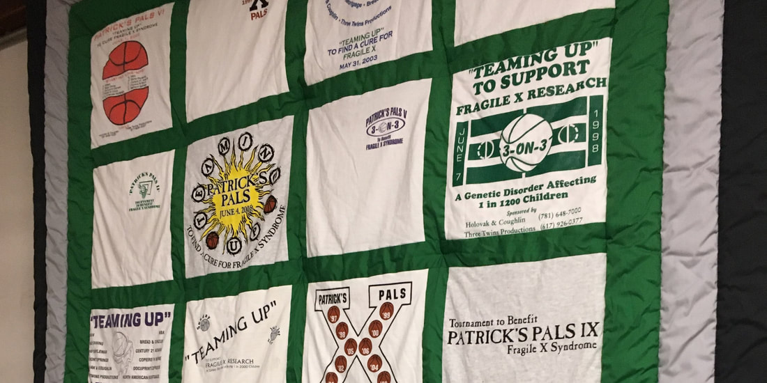 Photograph of a quilt with different t-shirt prints in each square - all of them designs for Patrick's Pals basketball event