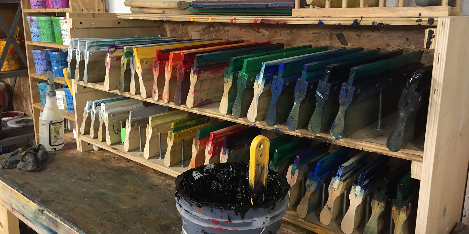 Photograph of screen printing squeegees with different colors of inks